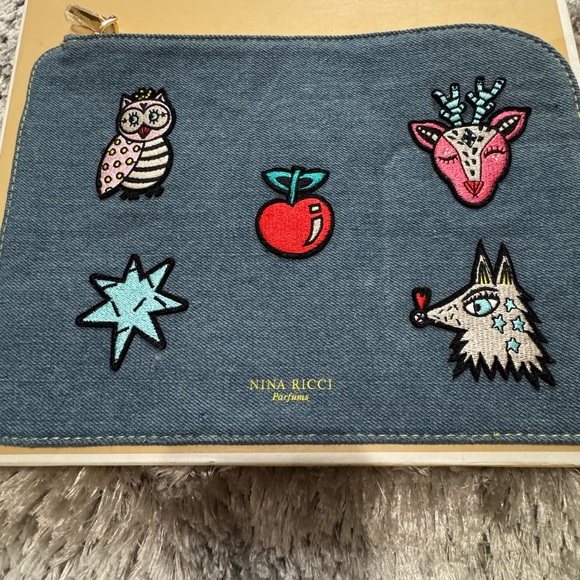 Nina Ricci Handbags - Nina Ricci Blue Cosmetic Bag with Embroidered Designs